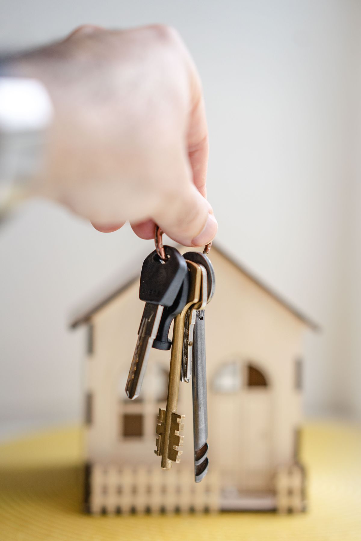 House keys held in front of a model home