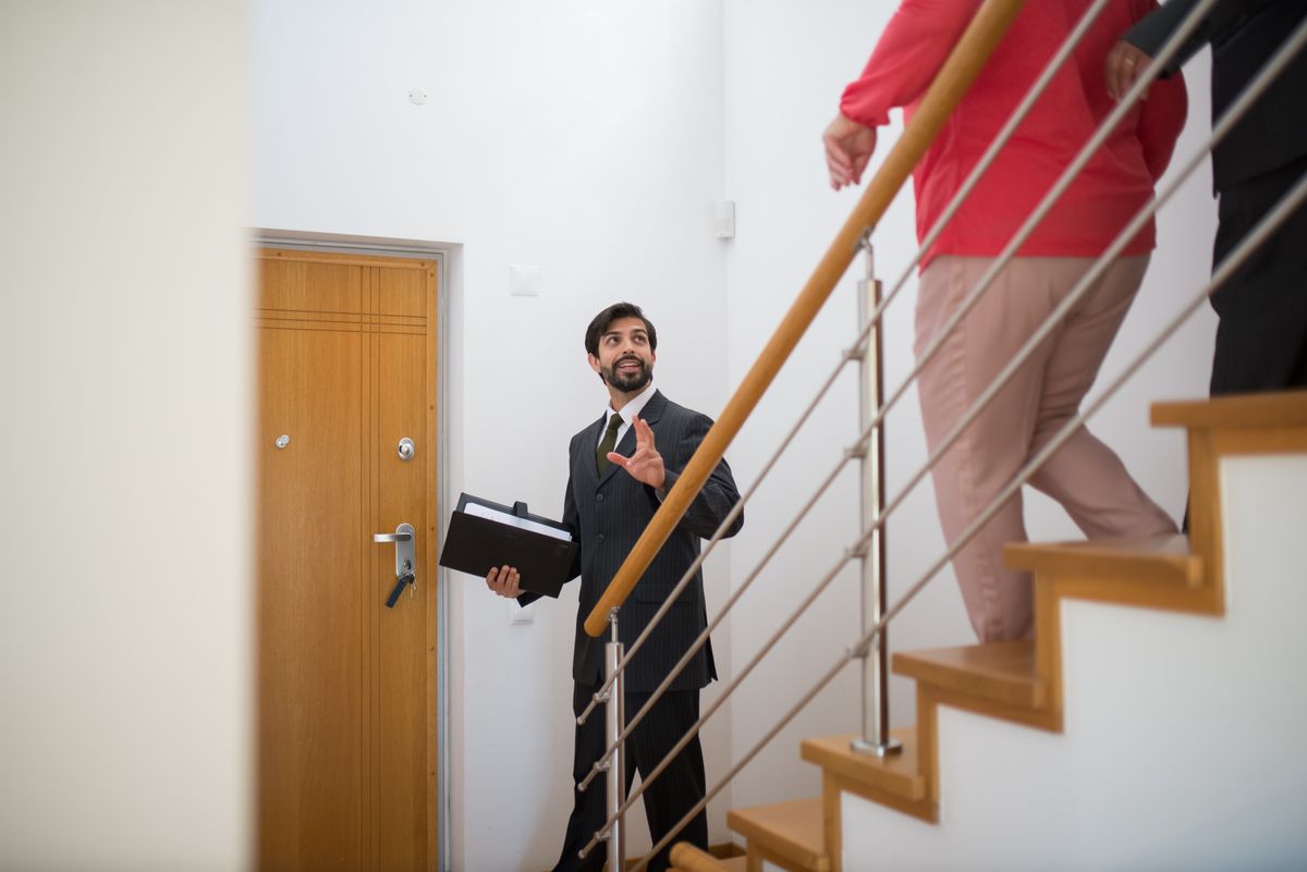 An estate agent welcoming people to view a property